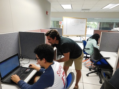 Section Leader Ben helps a student debug an issue in the GS 228 lab